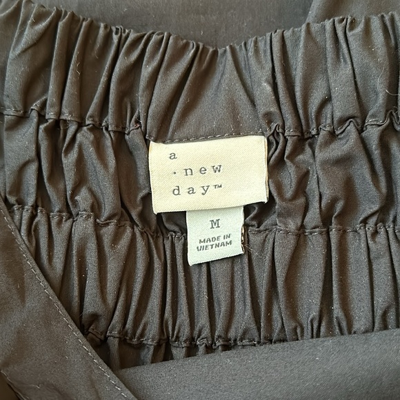 A New Day black dress size medium with a tan Universal Thread cross body purse. - Picture 15 of 16